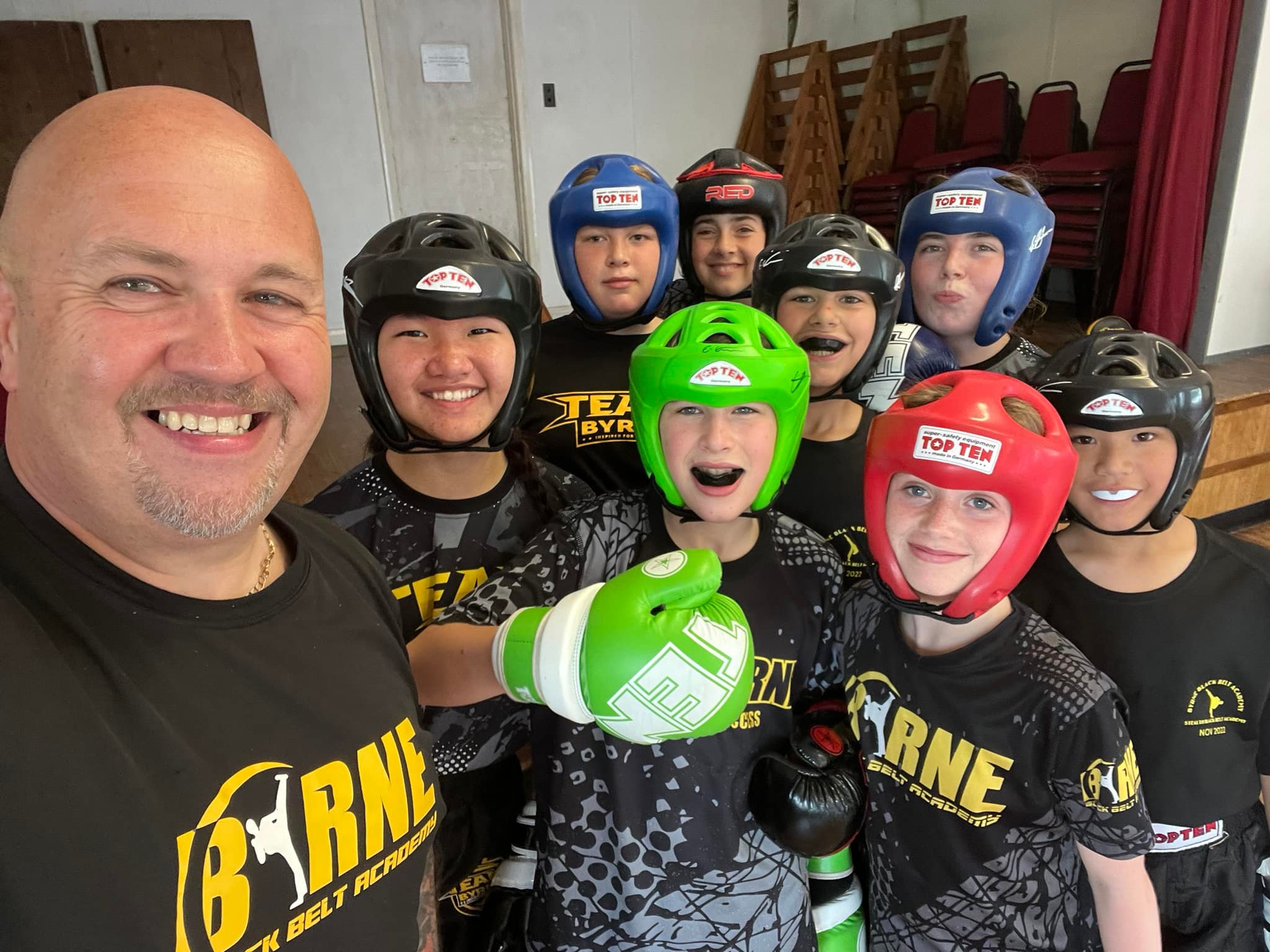 A coach and junior members in headguards at Byrne Black Belt Academy